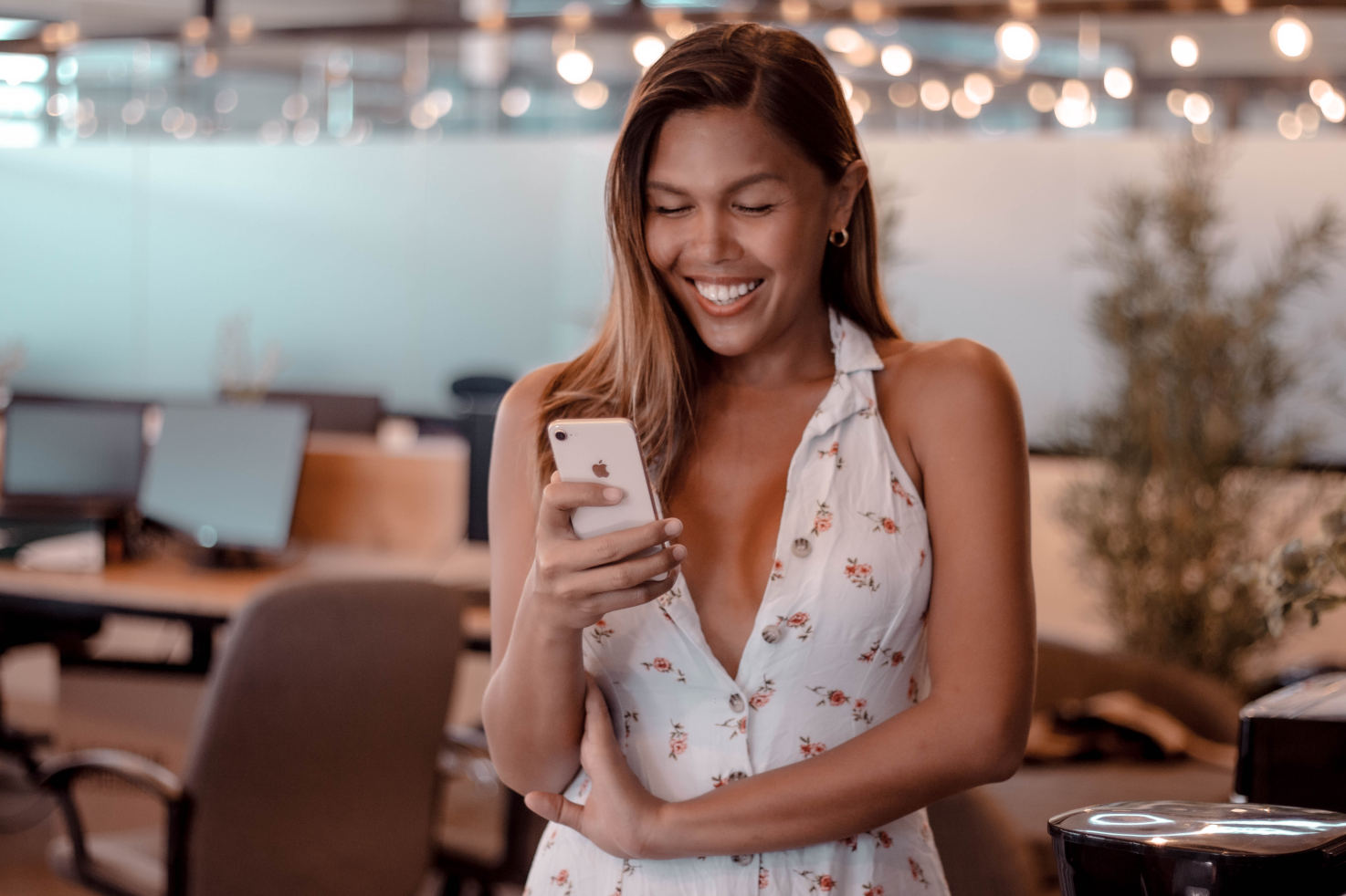 A ladyboy team member enjoying our top-rated dating app Portrait of a My Ladyboy Date team member smiling while using a smartphone, photographed to represent the mobile-friendly My Transgender Date app experience.