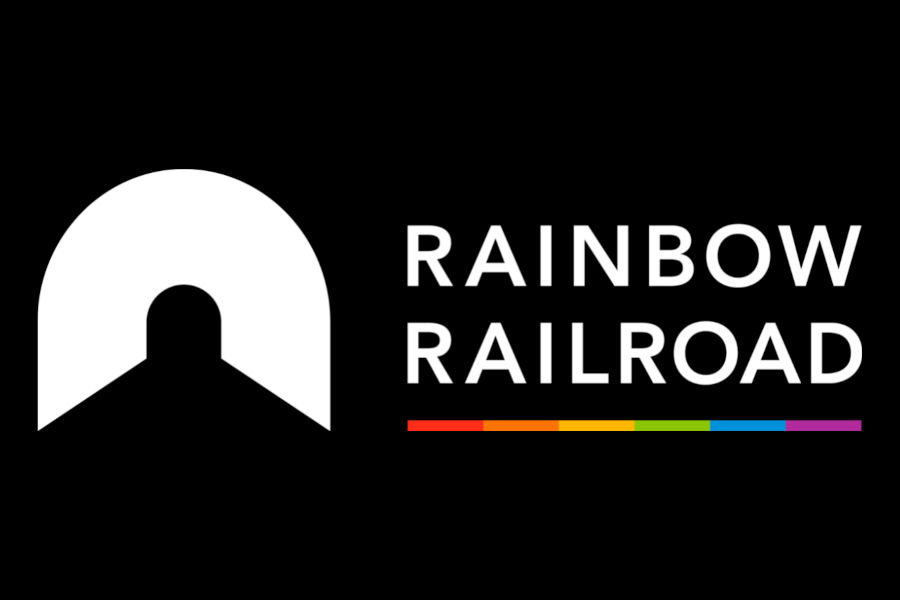 Logo of Rainbow Railroad featuring white text and a tunnel-shaped icon above a rainbow stripe on a black background.