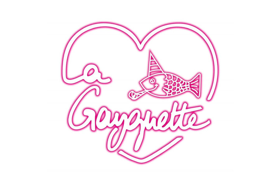 Logo of La Gayguette featuring pink handwritten-style text, a heart outline, and a cartoon fish wearing a party hat on a light background.