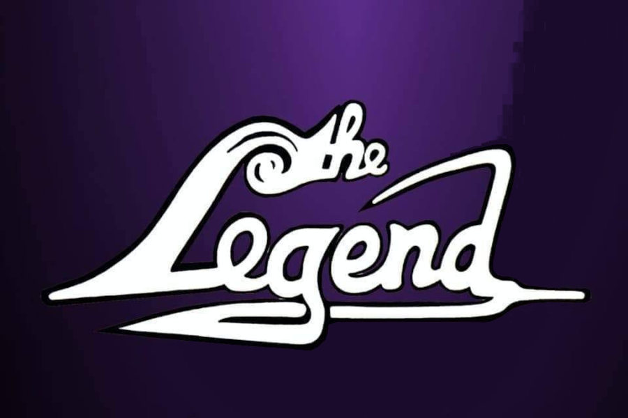 White script logo reading “The Legend” on a purple background for The Legend Bar & Restaurant.