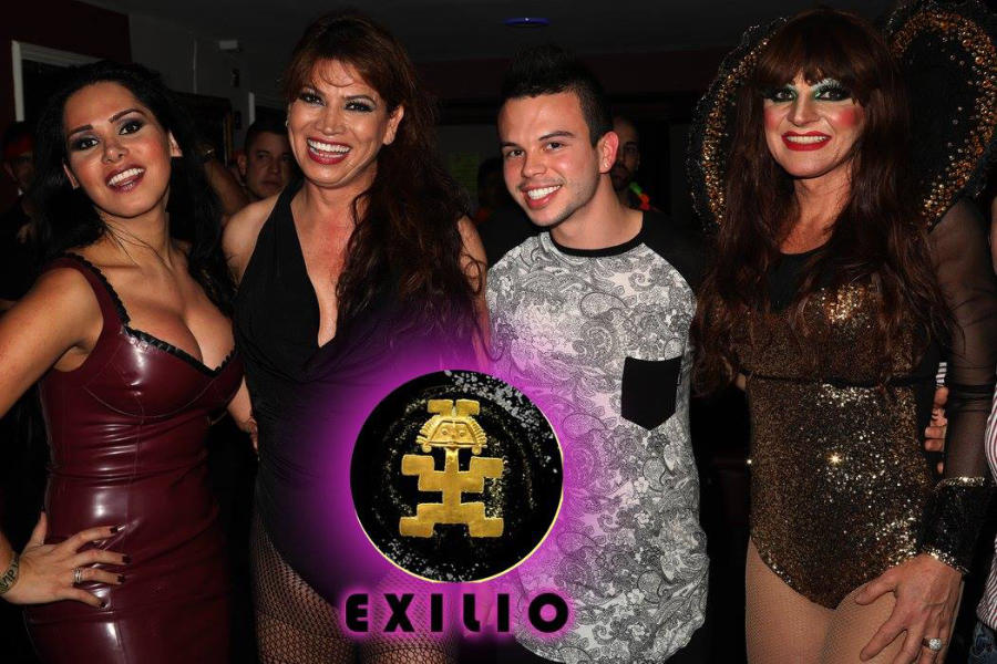 Four people posing together at Exilio Queer Latin Party inside Phoenix W1 nightclub in London during a lively LGBT event.