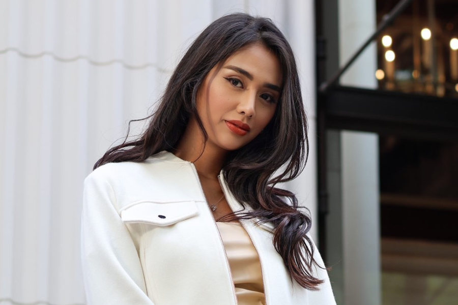 Qatrisha Zairyah photographed outdoors in Tokyo, looking composed in cream and black attire.