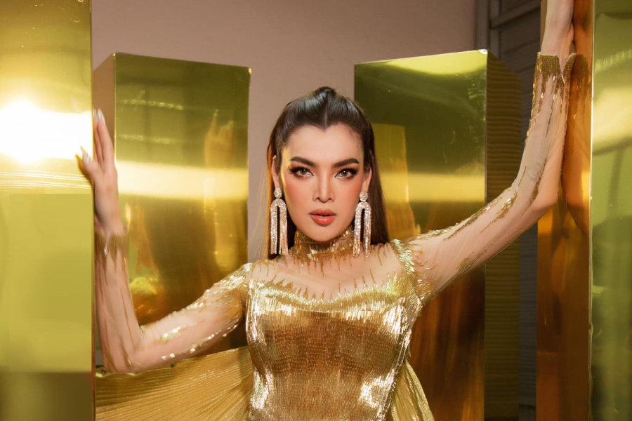 Trân Đài poses in a gold mini dress with matching cape, during her opening night stage show in Vietnam.